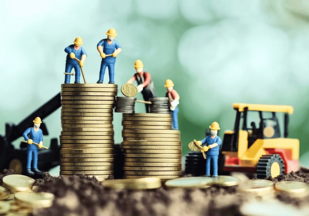 toy construction builders on stacked golden coins